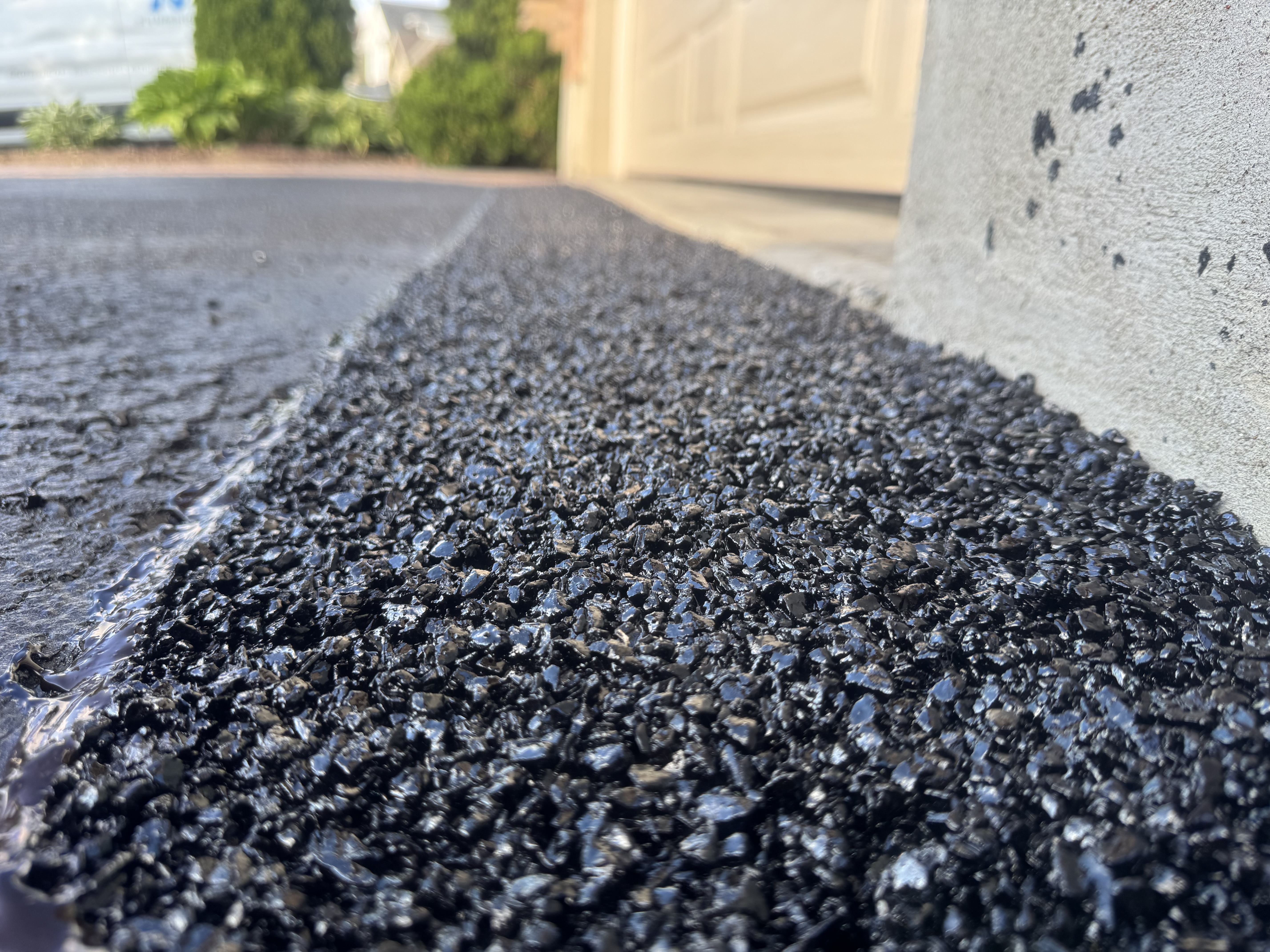 Close-up of cold patch asphalt texture on a new garage ramp installation