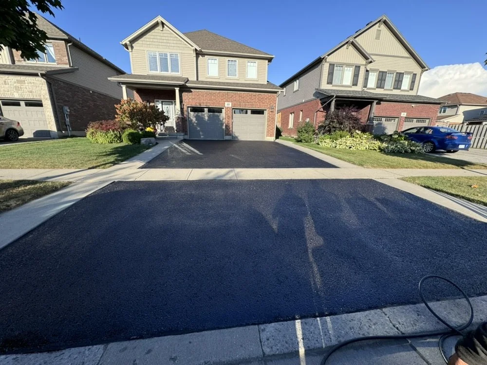 An image of a perfectly sealed driveway with some pothole asphalt repair