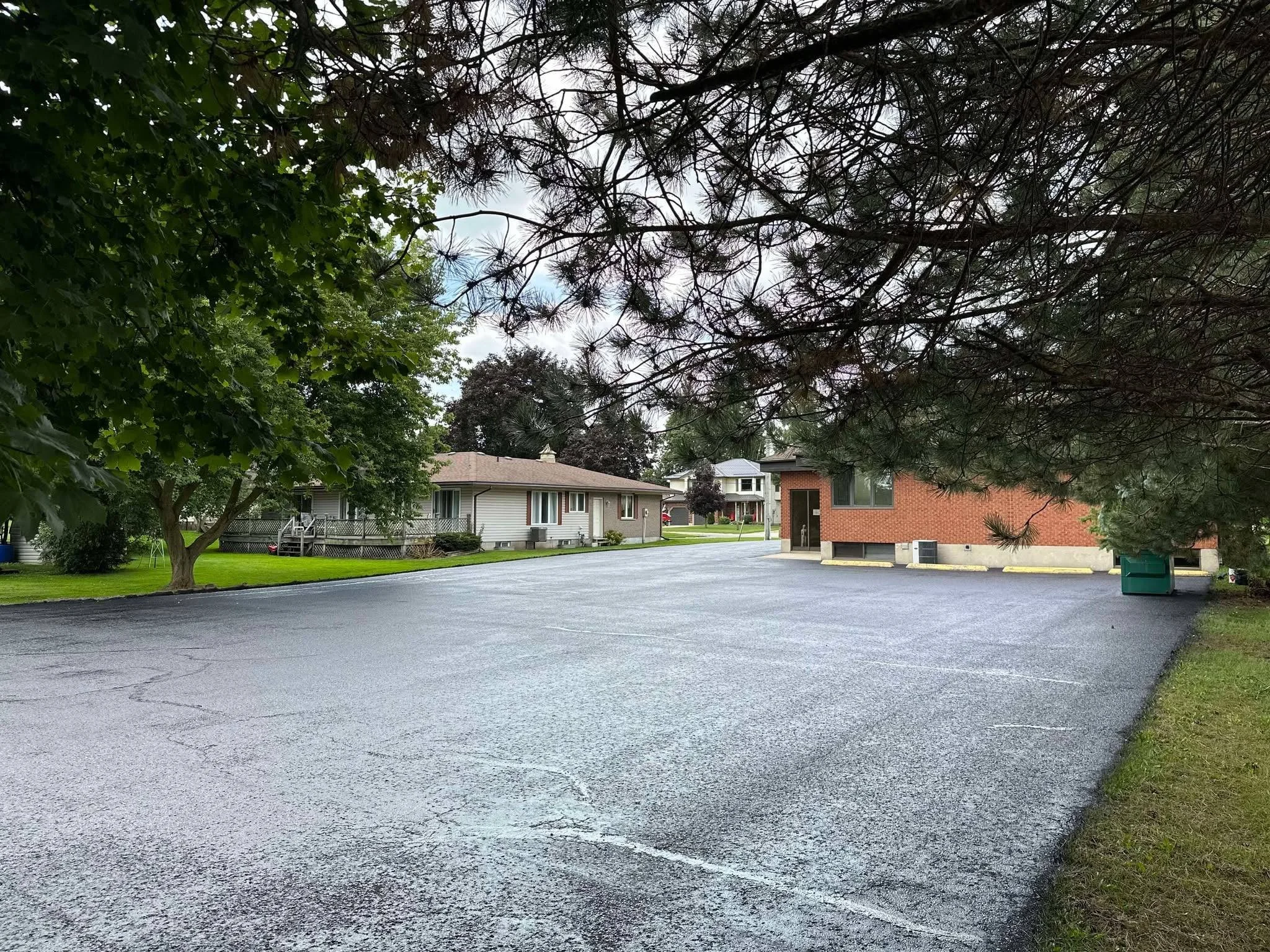 After photo of a freshly sealed asphalt parking lot showing the results of professional asphalt driveway sealing and crack filling