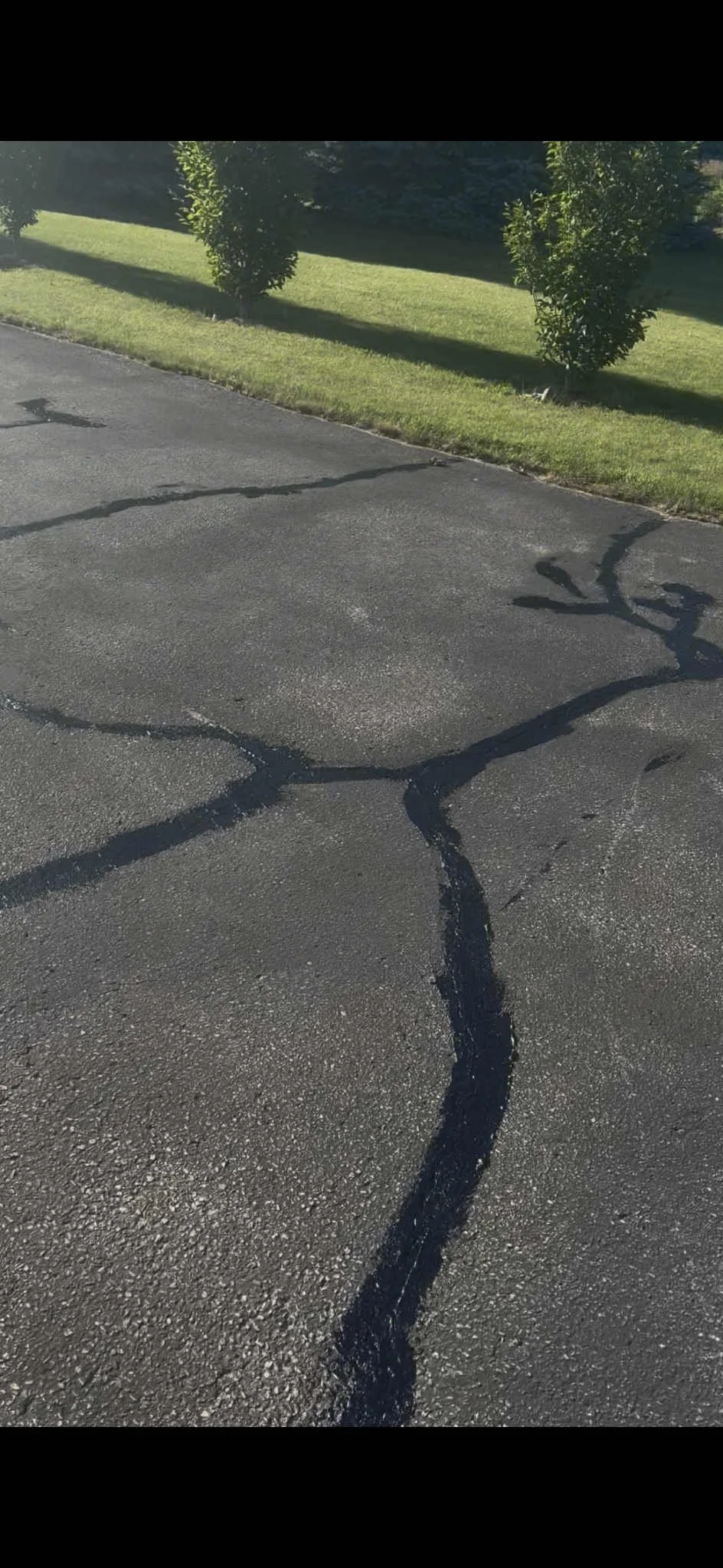 Driveway crack repair using hot rubber and cold pour filler